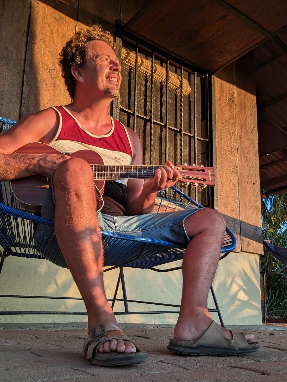 Ken playing guitar at sunset in Mexico